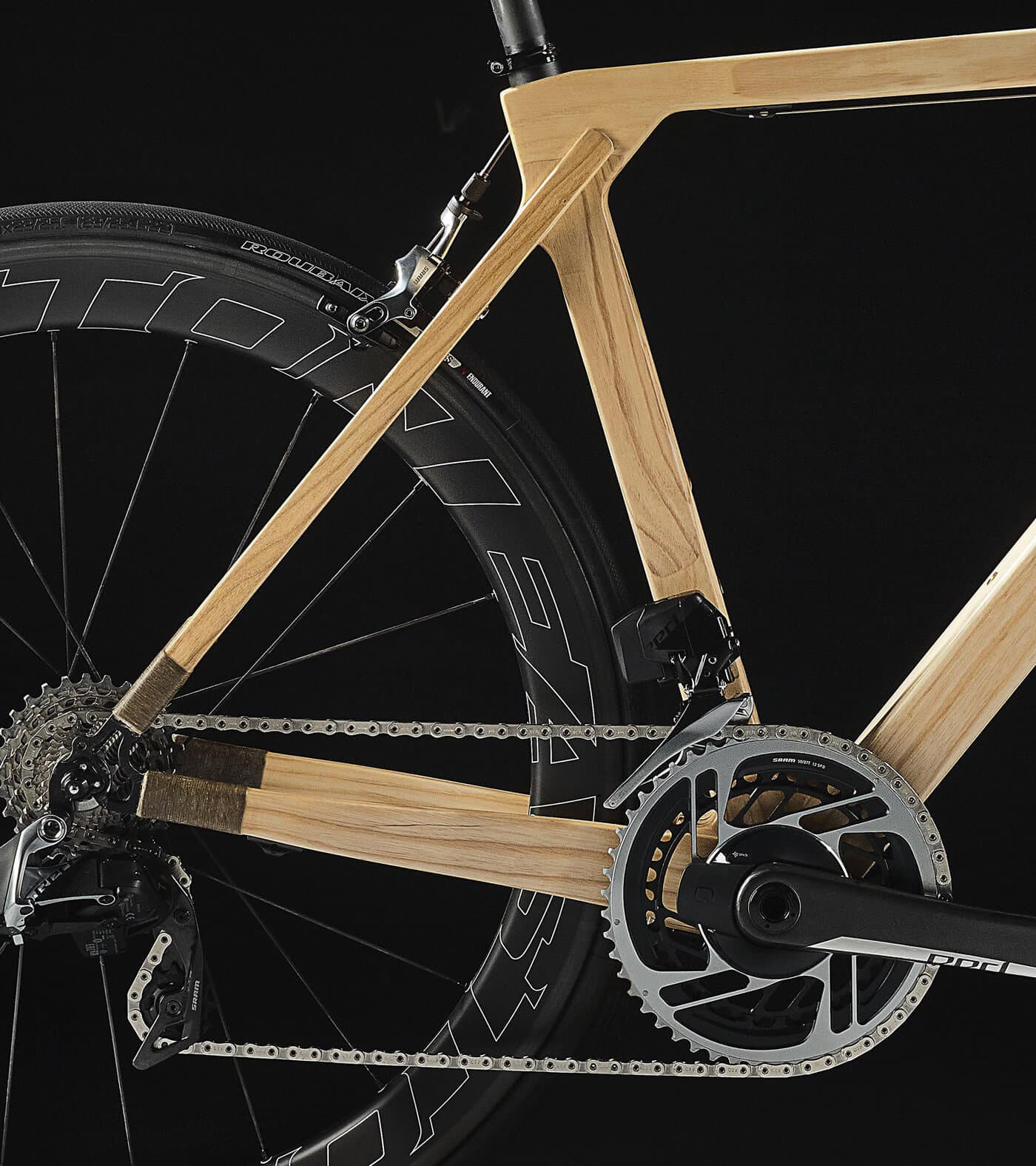 Close up of the frame and pedals of the SILA wooden road bike